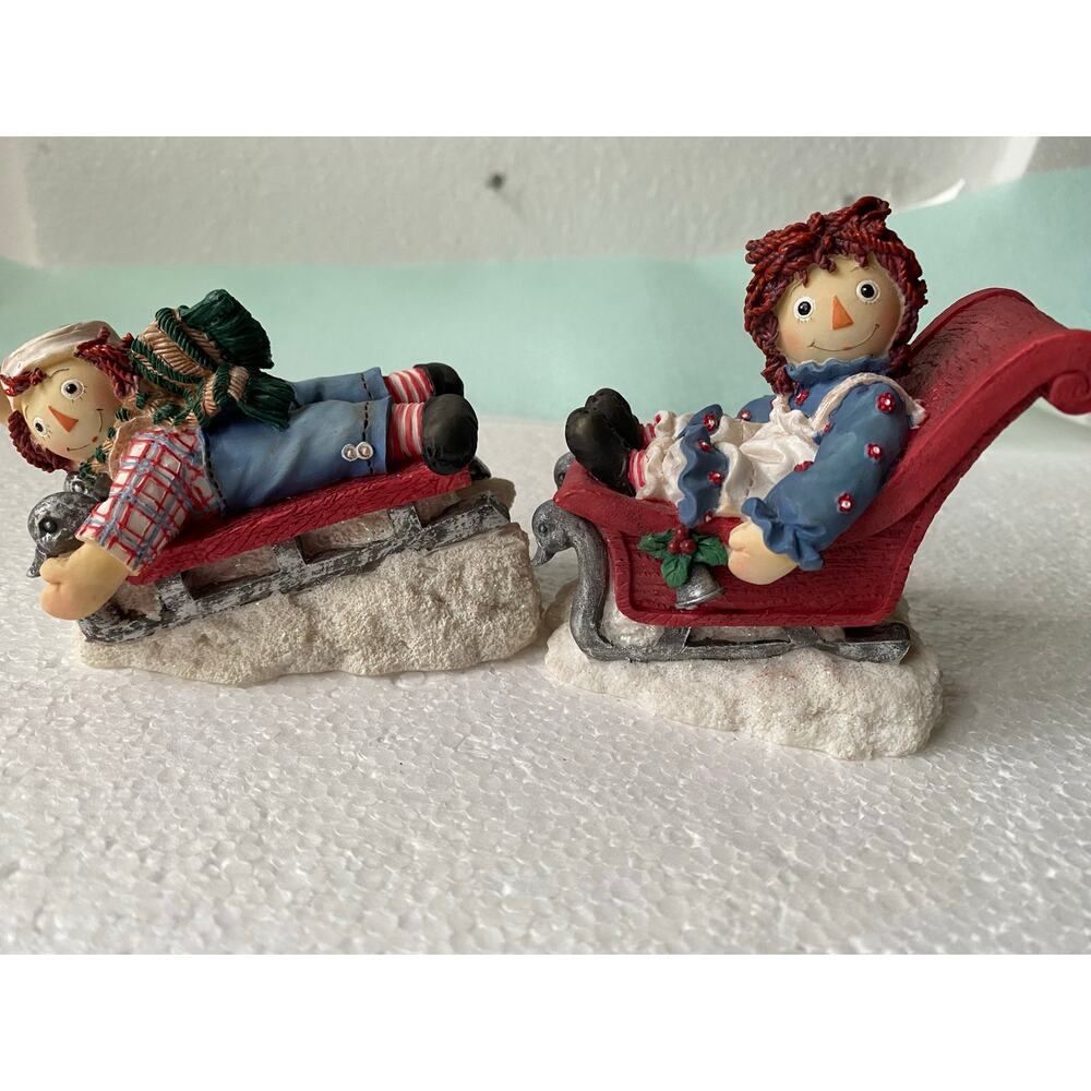 vintage Enesco figurine set features Raggedy Ann and Andy in a Christmas scene
